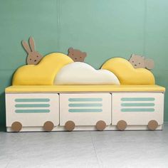 a child's bed with two teddy bears on top and one bear sleeping in the middle