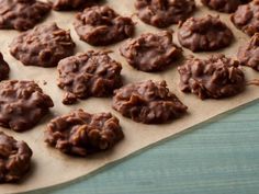 chocolate cookies sitting on top of a piece of parchment paper