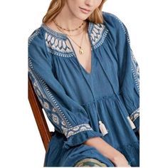 Broad Ruffle With Elegant Embroidery At The Neck And Sleeves And Feminine Appeal To This Tie-Neck Top By Free People. - Tie Closure - V-Neck - 3/4 Blouson Sleeves. Blue V-neck Embroidered Top With Floral Details, Blue Folk Style Top With Embroidered Hem, Blue Bohemian Top With Embroidered Neckline, Blue Long Sleeve Top With Embroidered Neckline, Bohemian Blue Embroidered Top With Geometric Patterns, Blue Folk Style Top With Embroidered Neckline, Blue Folk Embroidered Top With Neckline Detail, Blue Cotton Embroidered V-neck Top, Blue Folk Embroidered Top With Embroidered Neckline