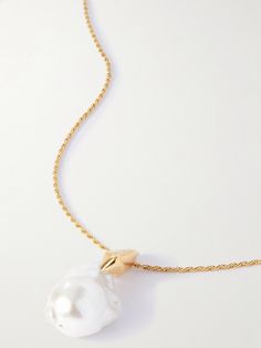 Bottega Veneta's necklace features a sculptural pearl. Crafted in Italy from gold-tone metal, it has an elongated chain that looks especially chic when framed by a v-neckline. Luxury Long Pearl Charm Necklace, Luxury Long Necklace With Pearl Charm, Formal Yellow Gold Chain Necklace With Pearl Charm, Luxury Pearl Chain Necklace, Luxury Pearl Necklace With Adjustable Chain, Luxury Pearl Chain Necklace With Round Pendant, Luxury Pearl Pendant Chain Necklace, White Pendant Chain Necklace For Formal Occasions, Luxury Gold-tone Jewelry With Pearl Pendant