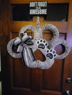 a door with a wreath and paw prints on it