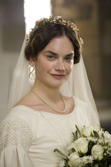 a woman in a wedding dress holding a bouquet