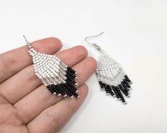 Style meets simplicity in these chic Black and White Woven Chevron Earrings. Handcrafted with love and attention to detail, these earrings are the epitome of minimalist elegance, making them a perfect addition to your jewelry collection. The classic black and white color combination is a timeless choice, ensuring these earrings effortlessly complement any outfit, from casual to dressy. The woven chevron design adds a touch of sophistication and uniqueness, setting these earrings apart from the o Minimalist Beaded Drop Earrings, Silver Minimalist Beaded Earrings, Minimalist White Beaded Dangle Earrings, Minimalist White Beaded Drop Earrings, Minimalist White Beaded Earrings As Gift, Minimalist White Beaded Earrings For Gifts, Minimalist White Beaded Earrings Gift, Earrings Casual, Chevron Earrings