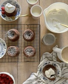 a table topped with plates and bowls filled with desserts on top of metal racks