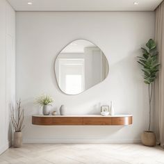 a white bathroom with a mirror, sink and potted plant