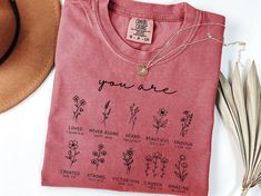 a t - shirt that says you are surrounded by flowers and other things to write on it