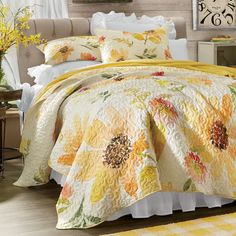 a bed covered in yellow and orange flowers