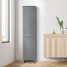 a bathroom with a tall gray cabinet next to a sink and mirror on the wall