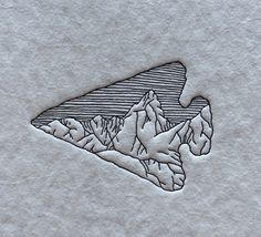 a piece of paper that has some type of mountain on it with mountains in the background