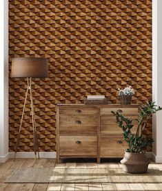 a room with a wooden cabinet and lamp on the side table next to a plant