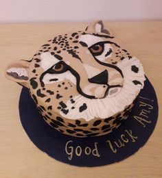 a cheetah cake with the words good luck on it's front and side