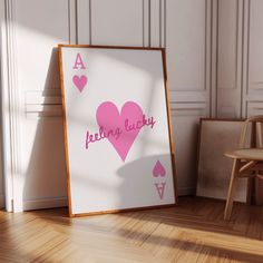 a wooden chair sitting next to a pink heart on top of a white board with the words believe lucky