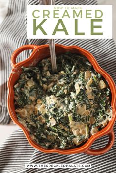 an orange bowl filled with spinach and cheese on top of a striped table cloth