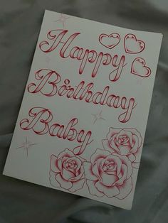 a happy birthday card with roses and hearts on the front is written in red ink