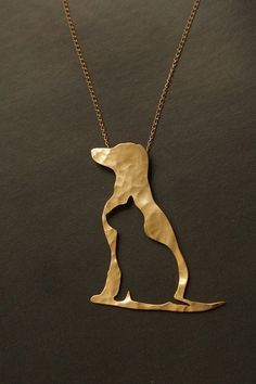 a gold necklace with a dog on it