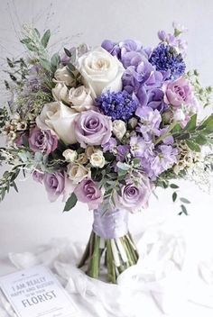 a bouquet of purple and white flowers in a vase