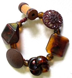 This is a beautiful, hand-made bracelet made with vintage brown plastic and wood buttons and coordinating beads on a sturdy elastic band.   All of my jewelry is hand-made, upcycled, and one -of-a-kind. Size: Small Buttons are approximately 1 to 1 and 1/2 " wide. A beautiful bracelet and a perfect gift for any occasion! Bohemian Brown Stretch Bracelet With Large Beads, Brown Stretch Bracelet With Wooden Beads, Handmade Vintage Brown Bracelets, Vintage Adjustable Stretch Bracelet With Large Beads, Handmade Adjustable Brown Stretch Bracelet, Adjustable Handmade Brown Stretch Bracelet, Button Bracelet, Wood Buttons, Bracelet Vintage