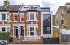 this is an image of a brick house with white trim on the front and windows