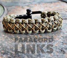 a close up of a bracelet on top of a stone surface with the words paracorl links written below it