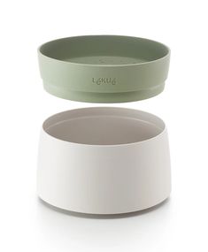 two bowls sitting side by side on top of each other, one green and the other white