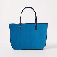 The Cerulean Cypress East West Tote is a large leather tote bag handmade in the USA with heirloom-quality craftsmanship and the very best materials. Cerulean Cypress is a thick and soft leather with a pillowy texture, even bright blue color, little to no pull-up, and pebbled grain. The Cerulean Cypress East West Tote comes standard with Navy handles. Best Tote Bags, Large Leather Tote Bag, Leather Tote Bags, Large Leather Tote, Tote Bags Handmade, Leather Handbags Tote, D Rings, Tote Bag Leather, Bag Handmade