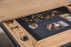 a wooden table topped with lots of cards and magnets on it's side