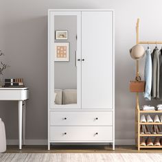 a white armoire sitting next to a desk