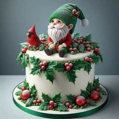 a christmas cake decorated with holly and gnome figurines