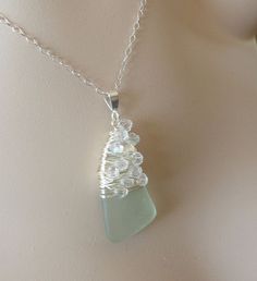 a necklace with a glass bead hanging from it