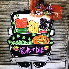 a sign on the side of a building that says ride or die with pumpkins and jack - o'- lanterns