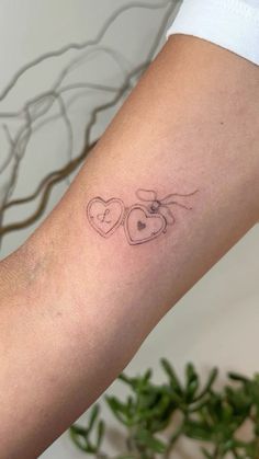 two hearts tattoo on the arm