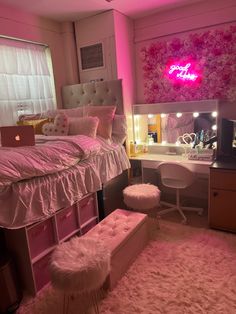 a bedroom with pink lighting and white fur rugs on the floor next to a bed