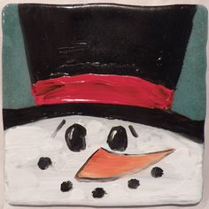 a painted snowman wearing a top hat