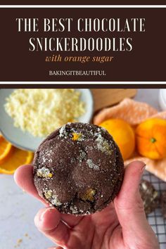 a person holding up a chocolate orange snickkerdoodle in front of some oranges