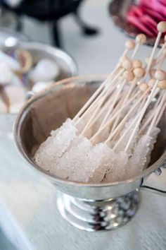 there are many skewers in the bowl on the table with cotton swabs