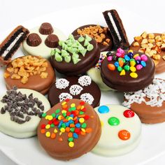 an assortment of decorated cookies on a white plate