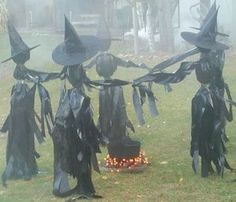 some witches are standing in the grass