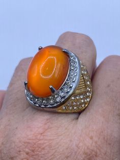 Large orange opal art glass Vintage ring Stainless Steel silver with gold finish not sterling. All rings are shipped in a nice gift box.   Check out our over a THOUSAND great reviews Engraving is $4 per letter and is not always perfect depending on the piece. It can take a few days if the jeweler is busy. This is payable to Paypal Judithsltd@gmail.com Formal Orange Cabochon Ring, Orange Oval Cabochon Jewelry For Formal Occasions, Orange Rings With Polished Finish For Anniversary, Formal Orange Oval Cabochon Jewelry, Gold Opal Ring Gift, Spiritual Round Orange Jewelry, Orange Spiritual Jewelry, Orange Cabochon Jewelry For Anniversary, Orange Polished Jewelry For Anniversary