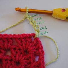 the crochet hook is next to an object that appears to be knitted