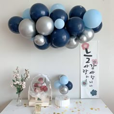 some balloons are hanging on the wall above a table