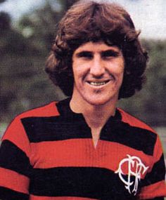 a card with the name of a woman in black and red striped shirt smiling at the camera