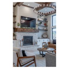 a living room filled with furniture and a flat screen tv mounted to the wall above a fireplace