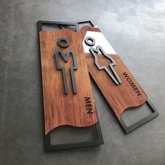 two wooden signs that say men and women on them, one is made out of wood