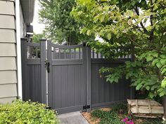 a gray gate in front of a house