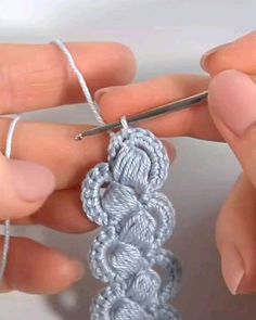 someone crocheting the end of a piece of yarn