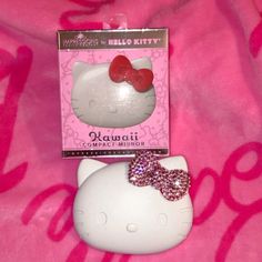 a hello kitty keychain with a pink bow on it's head and the box