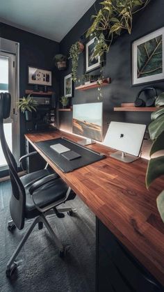 a desk with a laptop computer on top of it next to a potted plant