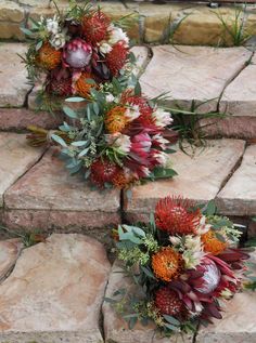 two bouquets of flowers sitting on top of stone steps