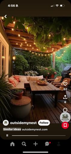 an outdoor patio with lights strung over the table and couches on the outside deck