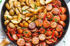 sausage and potatoes in a skillet with parsley on the side, ready to be eaten